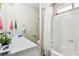 Bathroom with sink, white tile surround, toilet and shower/tub combination at 6409 Youngmont Ave, Las Vegas, NV 89103