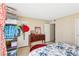 Bedroom features tiled floor, dresser, wardrobe, and access door at 6409 Youngmont Ave, Las Vegas, NV 89103