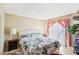 Well-lit bedroom features floral bedding, tile floor, sliding glass door, and ample closet space at 6409 Youngmont Ave, Las Vegas, NV 89103