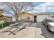 Charming single-story home with a yellow exterior, complemented by a well-maintained front yard and mature trees at 6409 Youngmont Ave, Las Vegas, NV 89103
