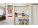 Galley kitchen features a breakfast bar with blue stools and ample natural light at 6409 Youngmont Ave, Las Vegas, NV 89103