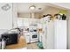 Functional kitchen featuring white cabinets and appliances, with a gas oven and hood at 6409 Youngmont Ave, Las Vegas, NV 89103
