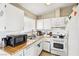 Functional kitchen featuring white cabinets and appliances, with a gas oven and hood at 6409 Youngmont Ave, Las Vegas, NV 89103