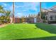 Landscaped backyard with artificial turf and gated access at 6541 Ashley Vale St, Las Vegas, NV 89131