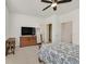 Main bedroom featuring a ceiling fan, walk-in closet, dresser and open access to the ensuite bathroom at 726 N Water St, Henderson, NV 89015