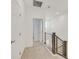 Upstairs hallway featuring wood and metal railing, carpet, and white doors at 726 N Water St, Henderson, NV 89015