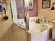 Bathroom with tub and shower, a large mirror, and updated vanity at 7820 Foxwood Pl, Las Vegas, NV 89145