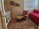 Charming bedroom with a comfortable recliner and a cozy rug at 7820 Foxwood Pl, Las Vegas, NV 89145