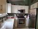 Full kitchen view, stainless steel appliances and white cabinets at 7820 Foxwood Pl, Las Vegas, NV 89145