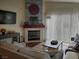 Cozy living room featuring a fireplace, comfortable seating, and a wood-look floor at 7820 Foxwood Pl, Las Vegas, NV 89145