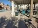 Covered patio area with tables and chairs near the pool at 7820 Foxwood Pl, Las Vegas, NV 89145