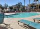 Community pool with lounge chairs and surrounding patio at 7820 Foxwood Pl, Las Vegas, NV 89145
