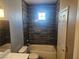 Modern bathroom with dark tile, bathtub, and updated vanity at 8309 Cherry Glaze Ave # 201, Las Vegas, NV 89145