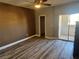 Bedroom with wood-look floors, access to balcony, and ceiling fan at 8309 Cherry Glaze Ave # 201, Las Vegas, NV 89145