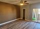 Bedroom with wood-look floors, access to balcony, and ceiling fan at 8309 Cherry Glaze Ave # 201, Las Vegas, NV 89145