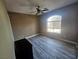 Spacious bedroom featuring wood-look floors and large window at 8309 Cherry Glaze Ave # 201, Las Vegas, NV 89145