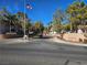 Ironwood Condominiums entrance with American flag, trees, and blue sky at 8309 Cherry Glaze Ave # 201, Las Vegas, NV 89145