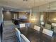 Elegant dining area with chandelier and modern table, adjacent to living space at 8309 Cherry Glaze Ave # 201, Las Vegas, NV 89145