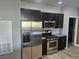 Modern kitchen features stainless steel appliances and tile backsplash at 8309 Cherry Glaze Ave # 201, Las Vegas, NV 89145