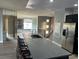 Modern kitchen with stainless steel appliances, sleek countertops and large island with barstool seating at 8309 Cherry Glaze Ave # 201, Las Vegas, NV 89145