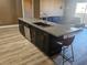 Sleek kitchen island with seating and modern finishes at 8309 Cherry Glaze Ave # 201, Las Vegas, NV 89145