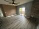 Bright living room featuring wood-look flooring, a decorative fireplace, and a sliding glass door to a balcony at 8309 Cherry Glaze Ave # 201, Las Vegas, NV 89145