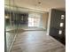 Elegant living room featuring mirror accent wall and modern light fixture creating a bright and inviting space at 8309 Cherry Glaze Ave # 201, Las Vegas, NV 89145