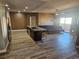 Open living room with kitchen island, hardwood floors, and modern furniture at 8309 Cherry Glaze Ave # 201, Las Vegas, NV 89145