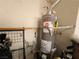 Performance Plus Rheem water heater installation with utility connections and adjacent storage at 8309 Cherry Glaze Ave # 201, Las Vegas, NV 89145