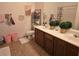 Bathroom with a double sink vanity, decorated with plants and macrame decor at 8985 S Durango Dr # 2062, Las Vegas, NV 89113