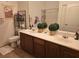 Bathroom with a double sink vanity, decorated with plants and macrame decor at 8985 S Durango Dr # 2062, Las Vegas, NV 89113