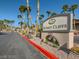 Well maintained Sunset Cliffs community entrance featuring professional landscaping and mature palm trees at 8985 S Durango Dr # 2062, Las Vegas, NV 89113