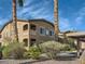 Exterior of a condominium with lush landscaping, palm trees, and covered parking at 8985 S Durango Dr # 2062, Las Vegas, NV 89113