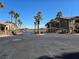Exterior view of a community gate surrounded by palm trees and well-maintained landscaping at 8985 S Durango Dr # 2062, Las Vegas, NV 89113