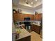 Bright kitchen featuring wooden cabinets, a corner sink, and stainless steel appliances at 8985 S Durango Dr # 2062, Las Vegas, NV 89113