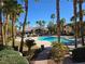Beautiful pool area with lounge chairs, palm trees, and a clubhouse in a landscaped setting at 8985 S Durango Dr # 2062, Las Vegas, NV 89113