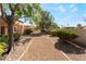 Desert landscaped common area with gravel and mature trees at 9621 Blue Bell Dr, Las Vegas, NV 89134