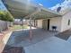 Backyard patio with covered seating area and small grassy yard at 1009 Winwood St, Las Vegas, NV 89108