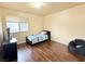 Bright bedroom with wood floors, featuring a twin bed and a beanbag chair at 1009 Winwood St, Las Vegas, NV 89108