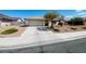 Ranch-style home with a single-car garage and nicely landscaped yard at 1009 Winwood St, Las Vegas, NV 89108
