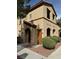 Two-story building exterior with Spanish-style architecture and landscaping at 10290 Gilmore Canyon Ct # 103, Las Vegas, NV 89129