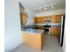 Modern kitchen featuring stainless steel appliances and wood cabinets at 10290 Gilmore Canyon Ct # 103, Las Vegas, NV 89129