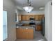 Kitchen with light wood cabinets, stainless steel appliances, and a breakfast bar at 10290 Gilmore Canyon Ct # 103, Las Vegas, NV 89129