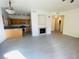 Living room with fireplace, kitchen, and laminate flooring at 10290 Gilmore Canyon Ct # 103, Las Vegas, NV 89129