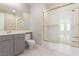 Bathroom featuring a shower with gold trim, a toilet, a sink, and a vanity with a large mirror at 11554 Lampeter Ct, Las Vegas, NV 89138