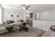 Relaxing living room with a ceiling fan and an adjacent built in workstation at 11554 Lampeter Ct, Las Vegas, NV 89138