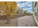 Landscaped backyard with retaining wall, pavers, and covered patio at 1189 Hillside Peak St, Henderson, NV 89002