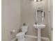 Bathroom with a pedestal sink, oval mirror, and neutral color palette at 1189 Hillside Peak St, Henderson, NV 89002