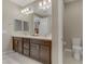 Bathroom features a double sink vanity with dark cabinets, tile flooring, and toilet at 1189 Hillside Peak St, Henderson, NV 89002