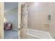 Bathroom featuring a tiled shower, bathtub, and a doorway to the bedroom at 1189 Hillside Peak St, Henderson, NV 89002